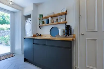 a kitchen with blue cabinets and a counter top at Westview in Newton Stewart