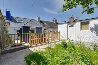 a wooden fence in front of a house at Westview in Newton Stewart