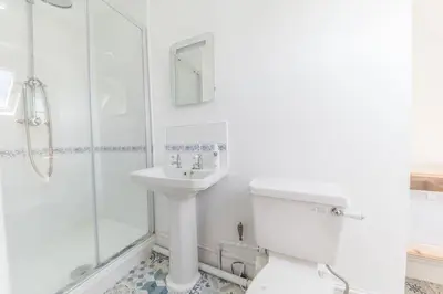 a bathroom with a sink and a toilet and a shower at Hazelgrove, Ratcliffe Place, Keswick in Keswick
