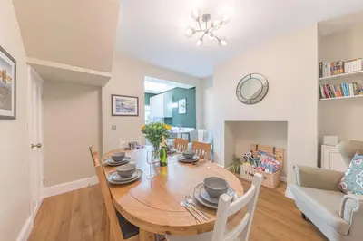 a dining room and living room with a table and chairs at Hazelgrove, Ratcliffe Place, Keswick in Keswick