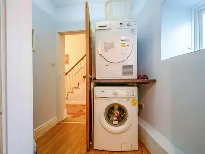a washing machine with a microwave on top of it at Oak Lodge in Keswick