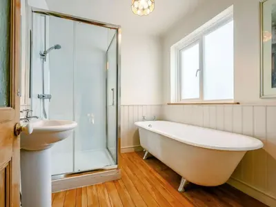a bathroom with a sink and a tub and a shower at Oak Lodge in Keswick