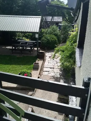a view of a garden from the balcony of a house at NEWFIELD INN in Broughton in Furness