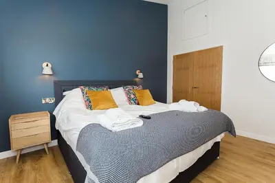 a bedroom with a bed with towels on it at Cairn Dyke Lodge in Gatehouse of Fleet