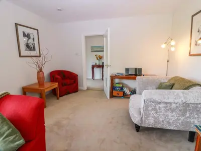 a living room with a couch and a chair at Knockendoch in Dumfries