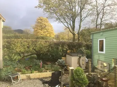 a garden with a green house in the middle of it at Lakeland Retreat in Lamplugh