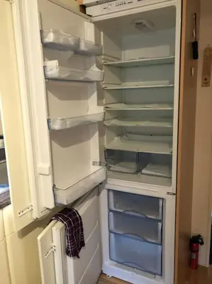 an empty refrigerator with its door open in a kitchen at Lakeland Retreat in Lamplugh