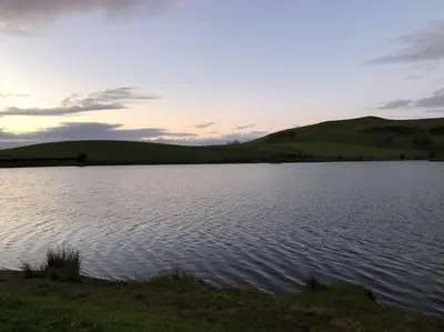 a large body of water with hills in the background at Lakeland Retreat in Lamplugh