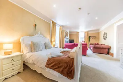 a bedroom with a bed and a living room at Abbey Farm House in St Bees