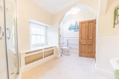 a bathroom with a shower and a sink and a toilet at Abbey Farm House in St Bees