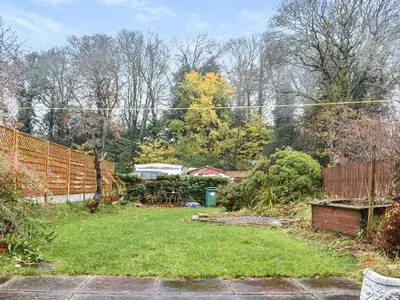 a backyard with a fence and a grass yard at Tynedale in Keswick