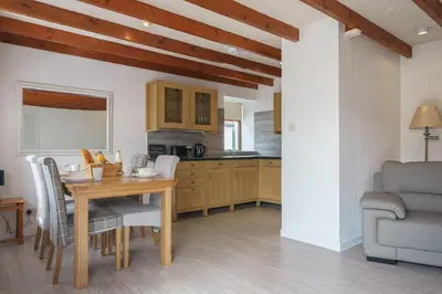 a kitchen and dining room with a table and chairs at Morton Cottage in Thornhill