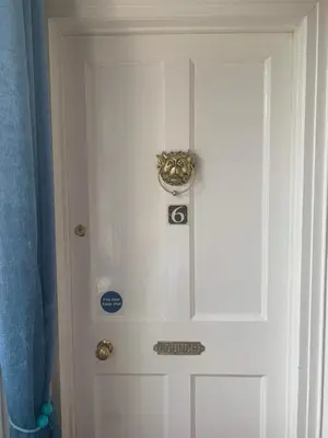 a white door with a sign on it at Seamore House in Moffat
