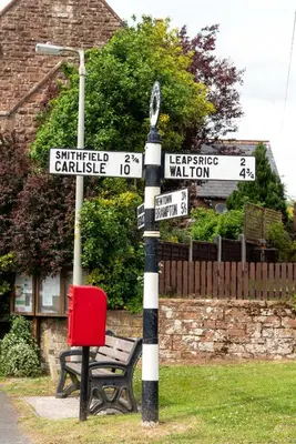 a black and white pole with street signs on it at Cottage - Sleeps 4 hot tub & pet friendly in Carlisle