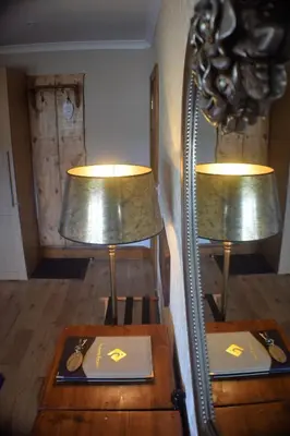 two lamps sitting on a table in a room at Riverside Escape in Keswick