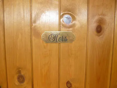 a door with a sign that says hers on it at Riverside Escape in Keswick
