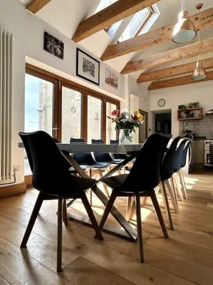 a dining room with a table and chairs at Southcliff House in Portpatrick