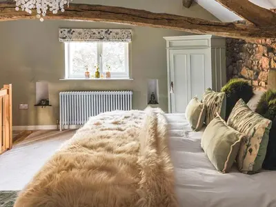 a bedroom with a large white bed with a blanket at The Nook - Uk44735 in Tallentire
