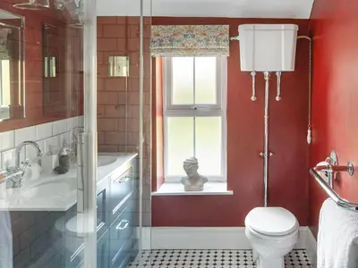 a bathroom with a toilet and a sink and a window at The Nook - Uk44735 in Tallentire