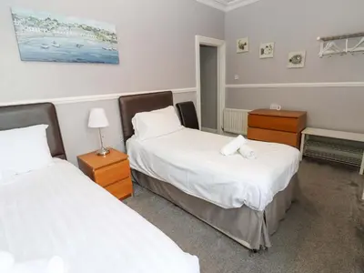 a bedroom with two beds and two night stands at Fern Lee in Carlisle