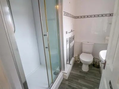 a bathroom with a toilet and a glass shower at Fern Lee in Carlisle