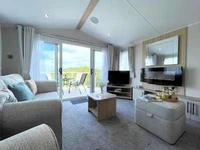 a living room with a couch and a tv at Gorgeous Kippford Home With Outstanding Views - Pass the Keys in Kippford