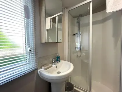 a bathroom with a sink and a shower at Gorgeous Kippford Home With Outstanding Views - Pass the Keys in Kippford