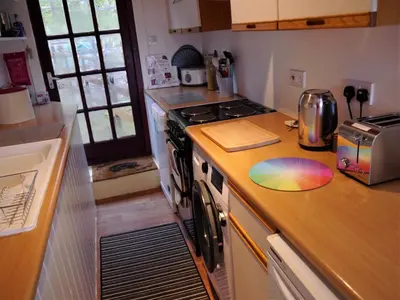 a kitchen with a stove and a counter top at Kippford Stables in Kippford