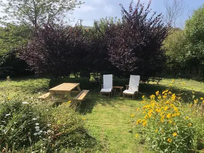 two chairs and a picnic table in a garden at Portling View in Dalbeattie
