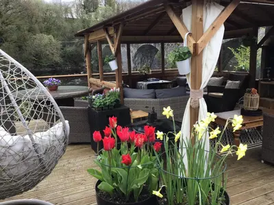 a patio with flowers in pots on a deck at The Haven B&B in Castle Douglas