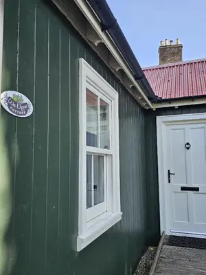 a green building with a white window and a door at Wee Dipper Cottage Maybole in Maybole