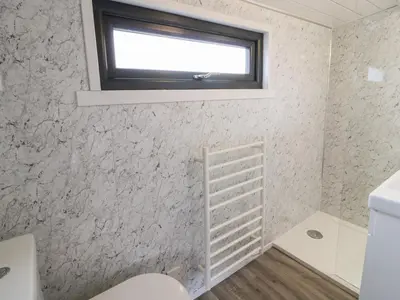 a bathroom with a toilet and a window at Greenacres Carriage in Maybole