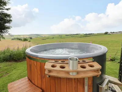 a hot tub in the middle of a field at Greenacres Carriage in Maybole