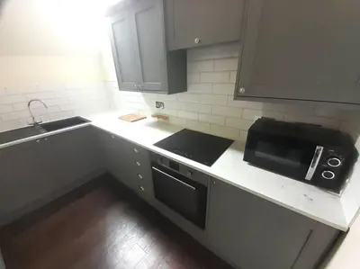 a kitchen with a counter top with a microwave at Kirkcudbright Holiday Apartments - Apartment F in Kirkcudbright