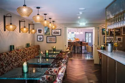 a restaurant with a bar and a dining room at Bridge House Hotel & Silver Howe View Cottage in Grasmere