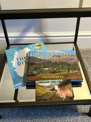 two books sitting on a glass table at Braithwaite House Rooms in Braithwaite