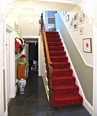 a staircase in a house with a red carpet at Maple Bank Country Guest House in Keswick