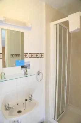 a bathroom with a sink and a shower at Keswick Park Hotel in Keswick