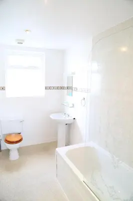 a bathroom with a toilet and a sink and a tub at Keswick Park Hotel in Keswick