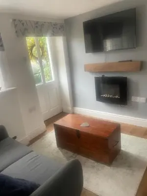 a living room with a couch and a fireplace at White House in Carlisle