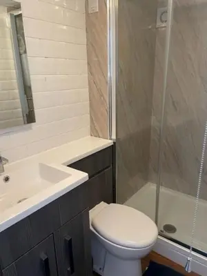 a bathroom with a toilet and a sink and a shower at White House in Carlisle