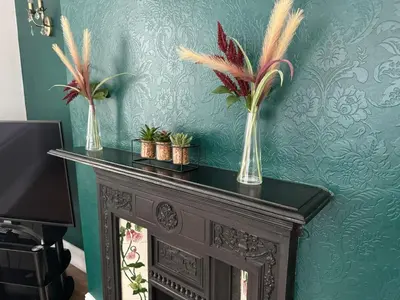 two vases with plants on top of a fireplace at Ennerdale Edge - 4 Bedrooms - Sleeps 8 in Cleator Moor