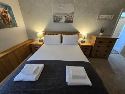 a bedroom with a large bed with two towels on it at The Plough Inn in Carlisle