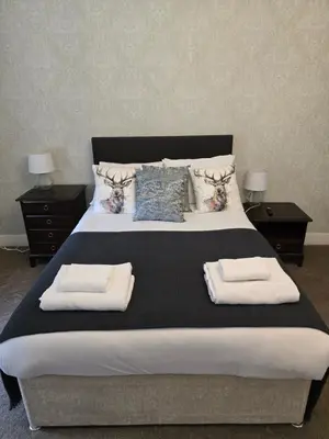 a bedroom with a large bed with towels on it at The Plough Inn in Carlisle