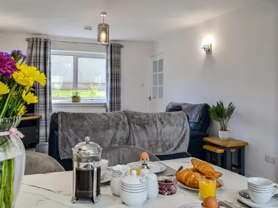 a table with food and croissants on top of it at Anchor Cottage in Portpatrick