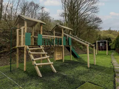 a playground with a slide and a ladder at Canadian Cabin No 38 in Keswick