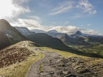 a dirt road on a mountain with mountains in the background at Canadian Cabin No 38 in Keswick