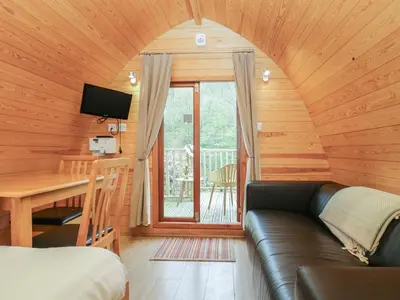 a room with a couch and a table and a window at Pod No 6 in Keswick