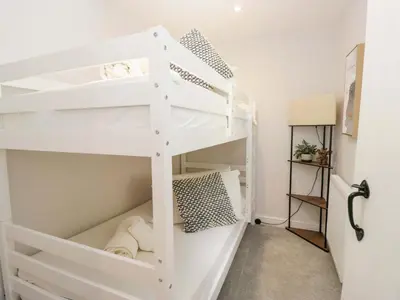 a white bunk bed in a small room at Riverside Cottage No 4 in Keswick