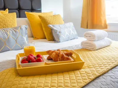 a tray of food and fruit on a bed at Mountain View Beautiful Large House By Cockermouth in Cockermouth